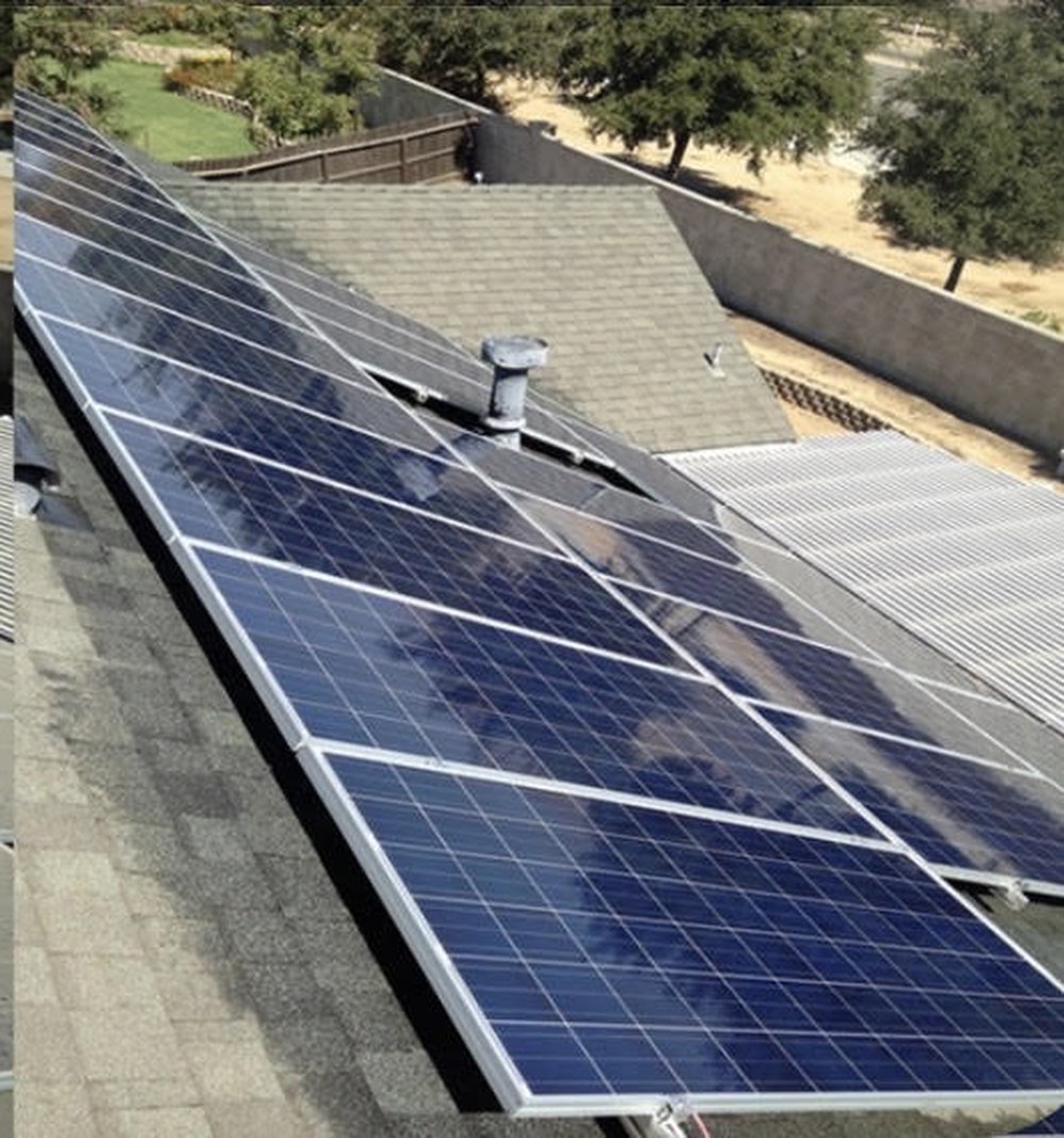 After, the same solar array washed clean so the panel glass is clear and dark