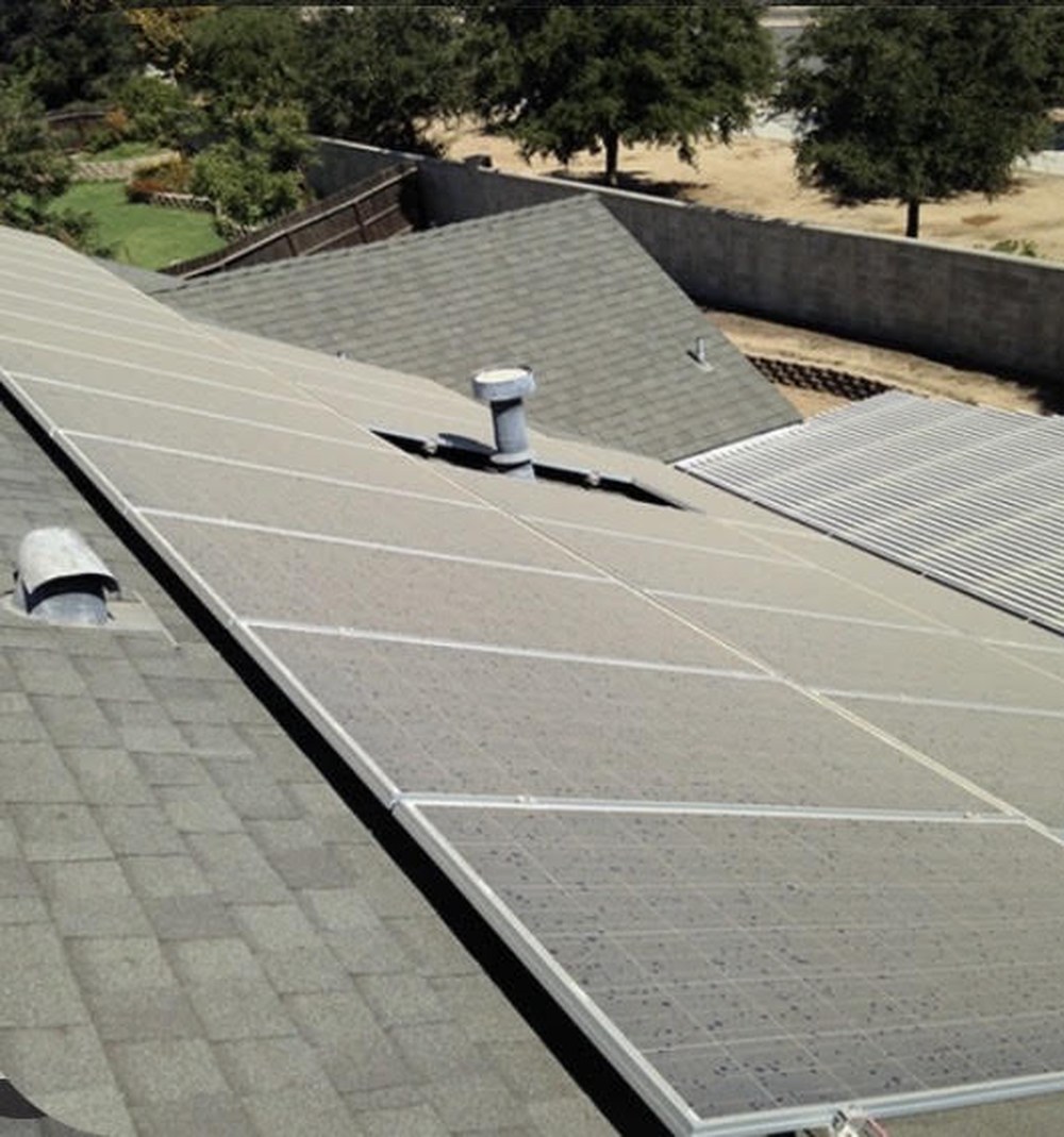 Before, a rooftop solar array dulled by a film of dust and grime