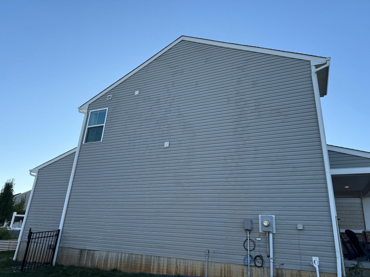 After, the same siding soft washed clean of algae streaking by Core Exterior Services