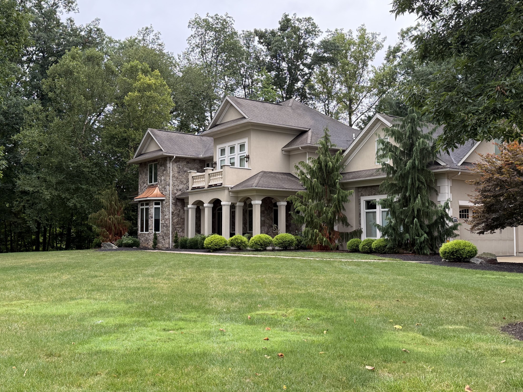 A large stone and stucco luxury home with pristine exterior cleaned by Core Exterior Services in Northeast Ohio