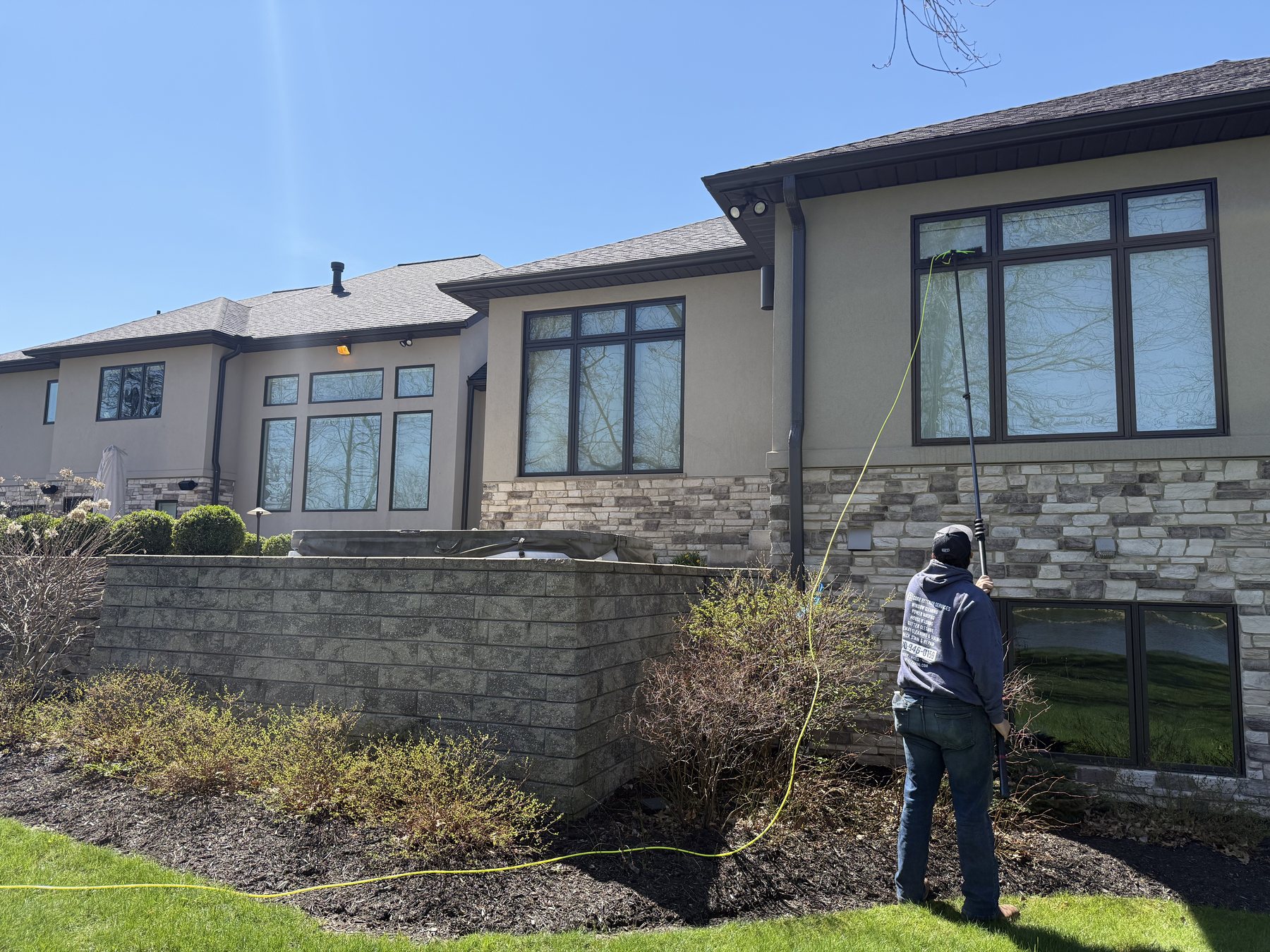 A large stone and stucco home soft washed clean by Core Exterior Services